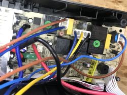 Inside a UPS: PCB with relays, connectors, and multicolored wiring