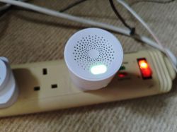 Gas sensor connected to a power strip with a green LED indicator.