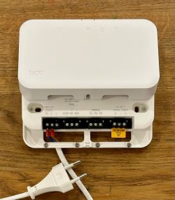 Tado Wireless Receiver V3+ with an open panel and visible electrical connections.