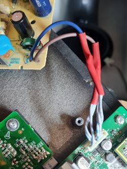 Close-up of modified electronics with visible wires and circuit boards.