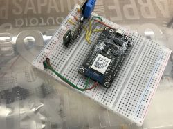 Electronic module placed on a breadboard with connected wires.