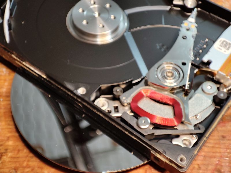 Flood-Damaged Hard Drive Interior Inside view of a hard drive showing platters and actuator arm.