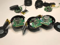 Three disassembled IP cameras with exposed electronics and Li-Po batteries.