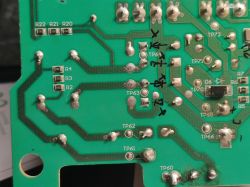 Close-up of a printed circuit board with marked components and test points.