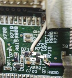 Close-up of a printed circuit board section with labeled voltages on wire connections.