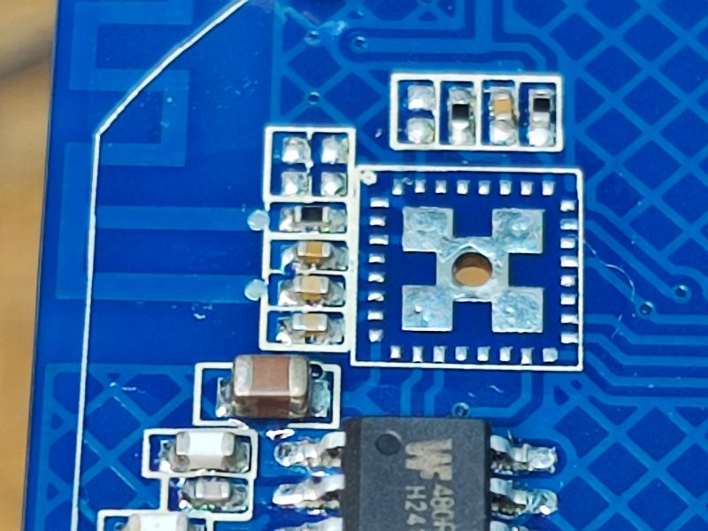 Circuit Board with IC and Solder Pads Close-up of a circuit board with an integrated circuit and solder pads.