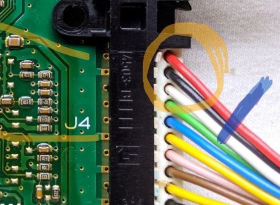 Close-up of a circuit board with marked wire section.