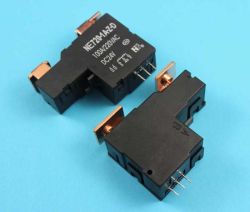 Two black bistable power relays marked NE2101-A1-5D with copper terminals and pins, lying on a blue background.