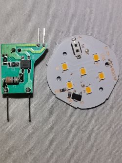 Disassembled LED module and electronic driver Two disassembled LED electronic modules on fabric background