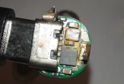 Corroded AA Battery Interior Close-up of a battery interior with visible electronic components and corrosion.