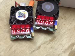 Load Testers on a Table Two load testers with LED displays on a table.