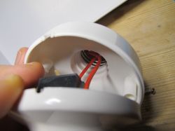 Interior of Plastic Casing with Wires Close-up of the interior of a plastic casing with red wires.