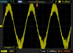 Distorted Waveform on Oscilloscope Oscilloscope displaying a distorted sine wave.