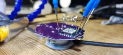Electronic circuit board with connected test leads.