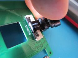 Camera module mounted on a circuit board labeled SENSOR.