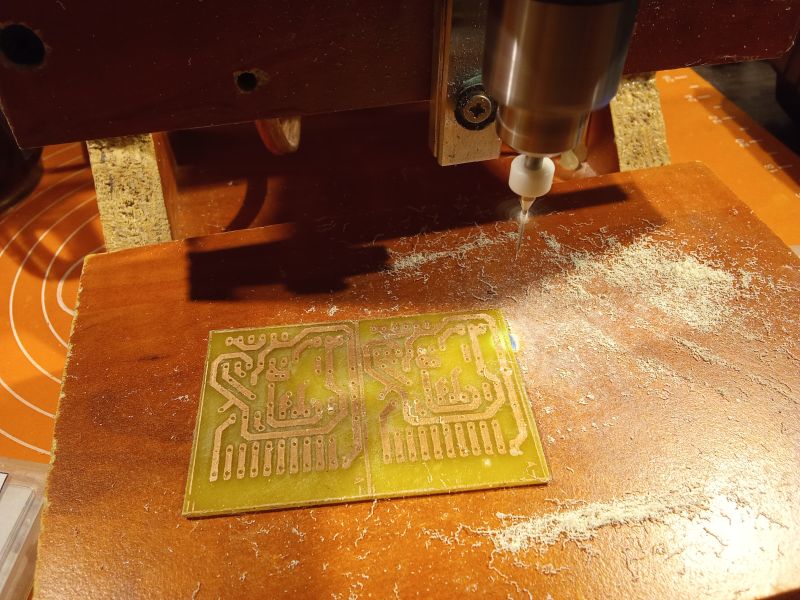 CNC machine milling a pattern on a printed circuit board.