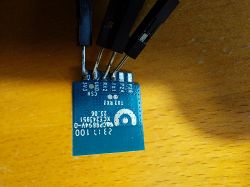 Microcontroller with Wires Microcontroller with connected wires on a wooden background.