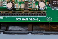 TCS MAIN V9.0-2 circuit board with electronic components Close-up of PCB labeled TCS MAIN V9.0-2. with visible electronic components