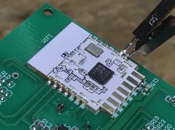 BK7231N WiFi Module on PCB during Programming Close-up of a CBU WiFi module with BK7231N chip soldered to a PCB and wires connected for programming.
