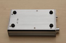 Headphone amplifier in a metal casing with four rubber feet.