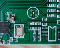 Photo of a printed circuit board with visible tracks and electronic components.