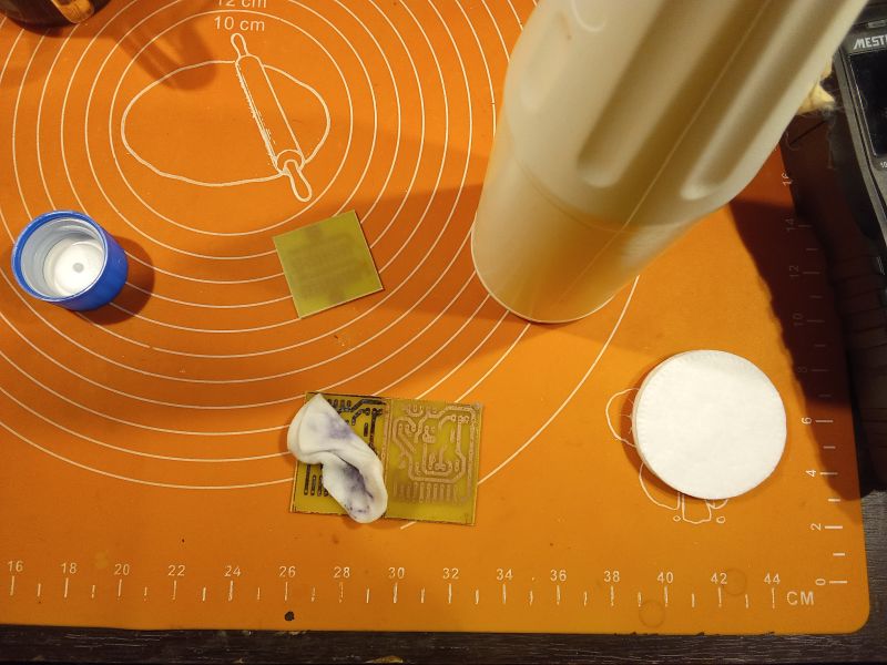 Items for PCB creation on an orange silicone mat.