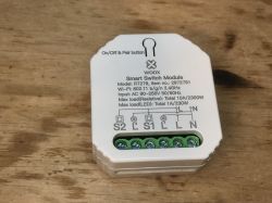 Woox R7279 Module with Visible Markings White Woox R7279 module with markings on the casing.