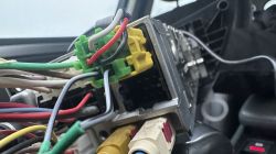 Close-up of connectors and wires inside a car.