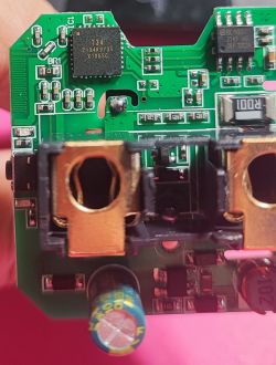 Circuit Board of QNCX Smart Plug Close-up of a circuit board from a smart plug, showing integrated circuits and components.