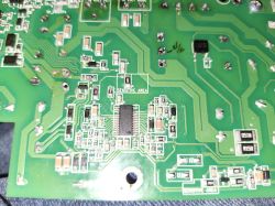 Section of a PCB with labeled SENSITIVE AREA Close-up of a green PCB with ICs and a marked SENSITIVE AREA zone