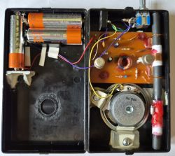 Inside view of a DIY AM radio with AA batteries, speaker, and electronic components
