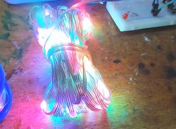 Bundle of WS2812B LEDs emitting multicolored light.