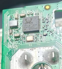 Close-up of a Realtek RTL8710CF microchip on a green PCB with visible electronic components.