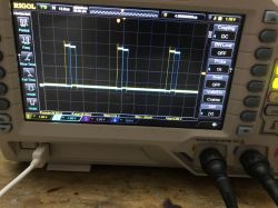 Oscilloscope screen displaying waveform signal.
