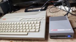 Atari XE Computer with Prototype Disk Drive XF 351 Atari XE computer and prototype disk drive XF 351 lying next to each other on a desk.