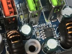 Inside View of LDNIO SEW3452 Power Strip with Electronic Components Close-up of a circuit board with electronic components, including USB ports and capacitors.