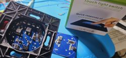Touch switch with a visible circuit board and packaging.