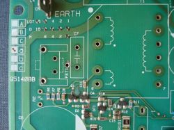 Circuit board with various electronic components and markings.