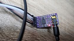 Electronic module with connected wires and a glowing LED.