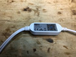 WiFi LED Controller WiFi LED controller on wooden background.