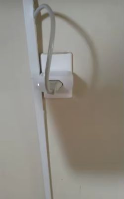 Plug with white cable connected to wall socket