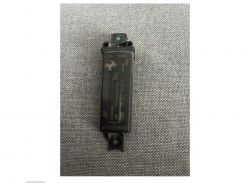 Czarna antena TMPS na szarej tkaninie.