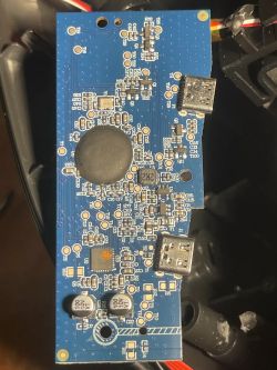 Blue PCB with SMD components and two USB Type-A ports, top-down close-up.