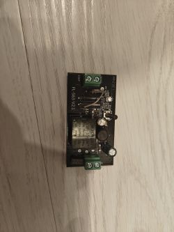 Motherboard with Yongwei Relay FL-S63-V2.1 motherboard with Yongwei Y3F-105DM relay on a wooden table.