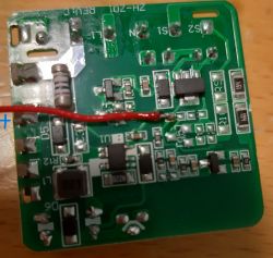 Image of a green circuit board with electronic components and a red wire soldered to one of the points on the board.