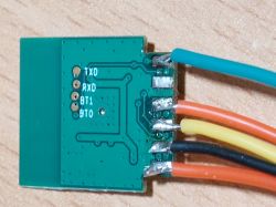 Close-up view of an ESP module with attached colored wires.