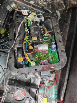 Close-up of the interior of a car tank with electronics and wires.