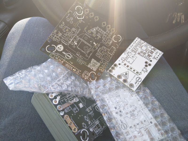 New PCB boards wrapped in bubble wrap on a lap.
