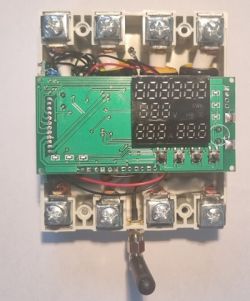 Interior of 3-phase SMTONOFF Energy Monitor with Main Circuit Board Disassembled SMTONOFF energy monitor showing main circuit board, screw terminals, and attached antenna.