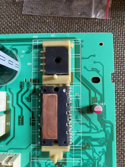 Zbliżenie na płytkę drukowaną ze sterownikiem pralki Whirlpool, z widocznym tranzystorem Mosfet pod radiatorem.